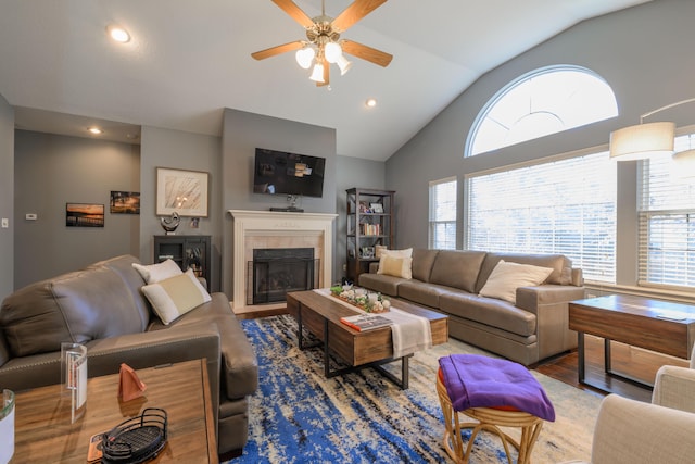 living room with lofted ceiling, recessed lighting, ceiling fan, wood finished floors, and a tile fireplace