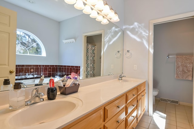 bathroom with visible vents, a sink, toilet, and tile patterned floors