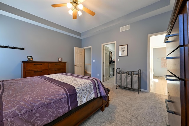 carpeted bedroom with baseboards, a spacious closet, visible vents, and a ceiling fan