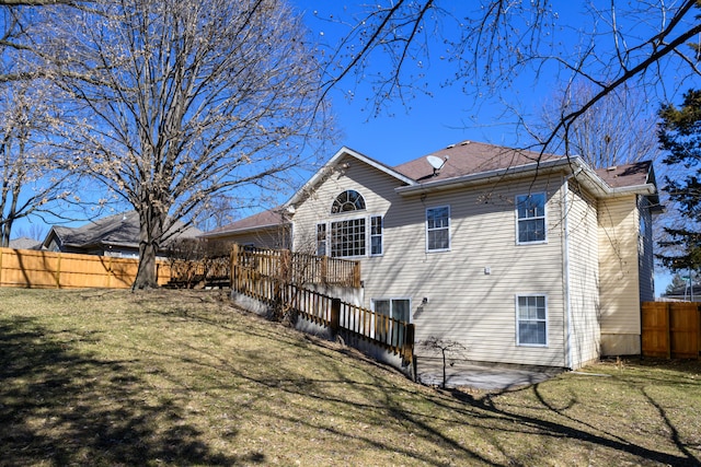 back of house featuring a yard, a patio area, fence, and a wooden deck