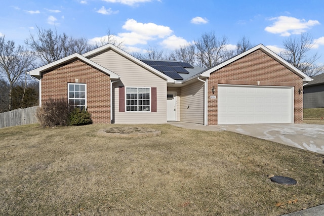 ranch-style home featuring driveway, a garage, solar panels, fence, and brick siding