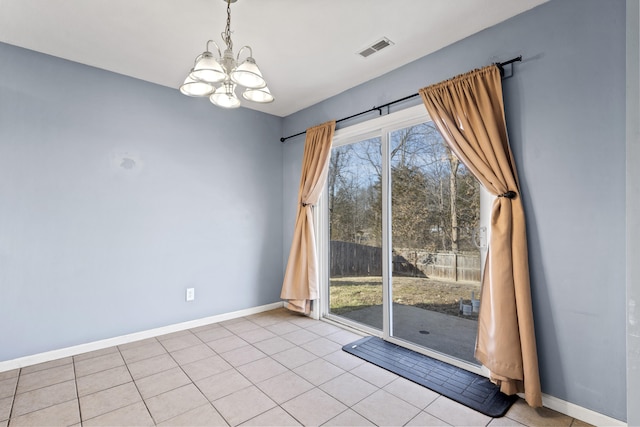 unfurnished room featuring a notable chandelier, baseboards, visible vents, and a healthy amount of sunlight