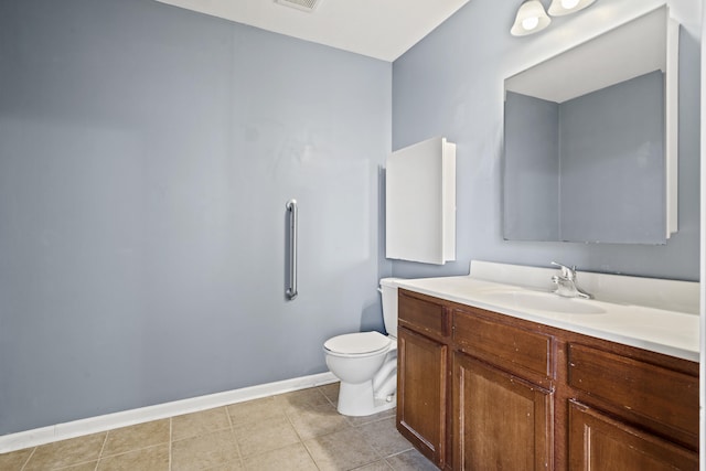 bathroom with toilet, tile patterned flooring, baseboards, and vanity