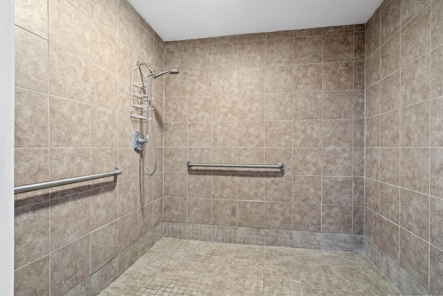 full bath with a tile shower