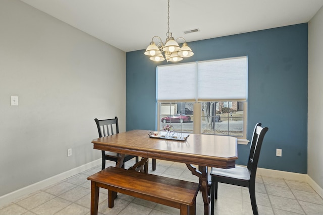 dining room with light tile patterned flooring, visible vents, baseboards, and an inviting chandelier