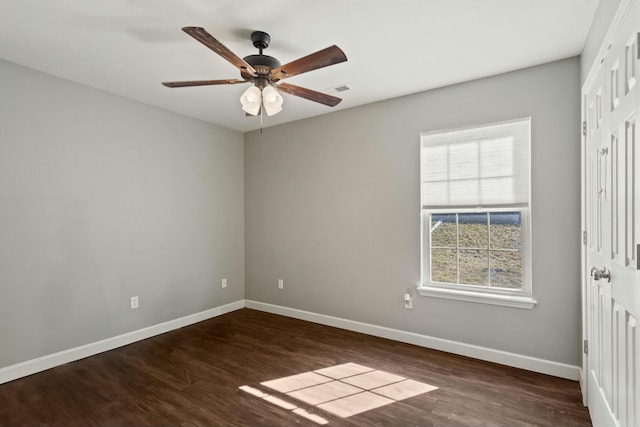 unfurnished room featuring ceiling fan, baseboards, and wood finished floors