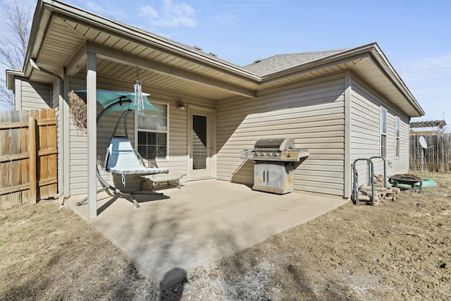 rear view of property with a patio area and fence