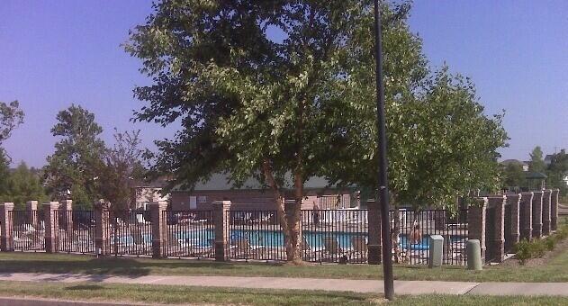 view of home's community with fence and a pool