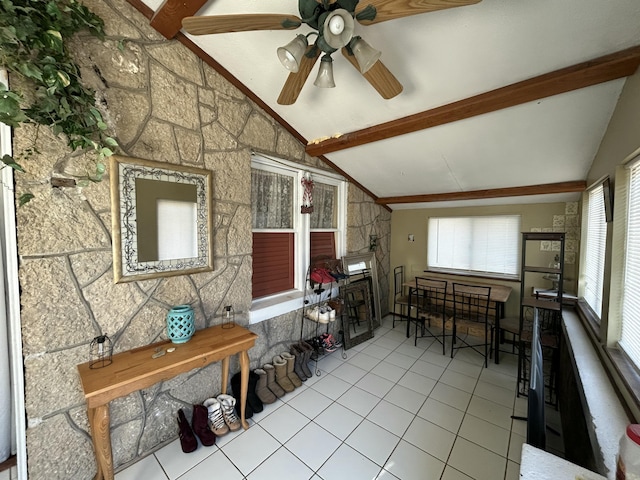 sunroom / solarium with lofted ceiling with beams and a ceiling fan