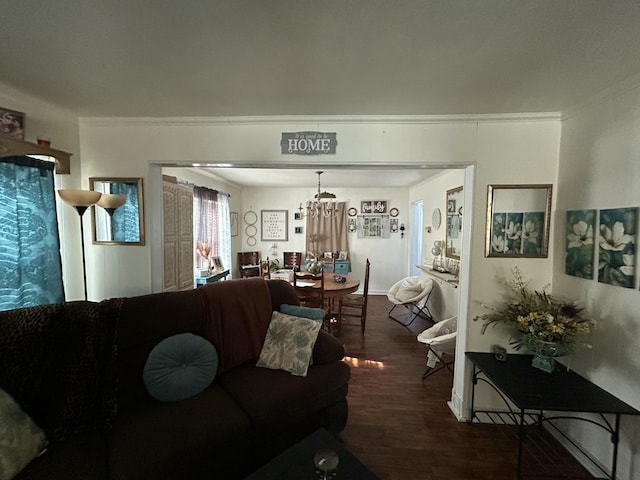 living area featuring a notable chandelier, crown molding, and wood finished floors