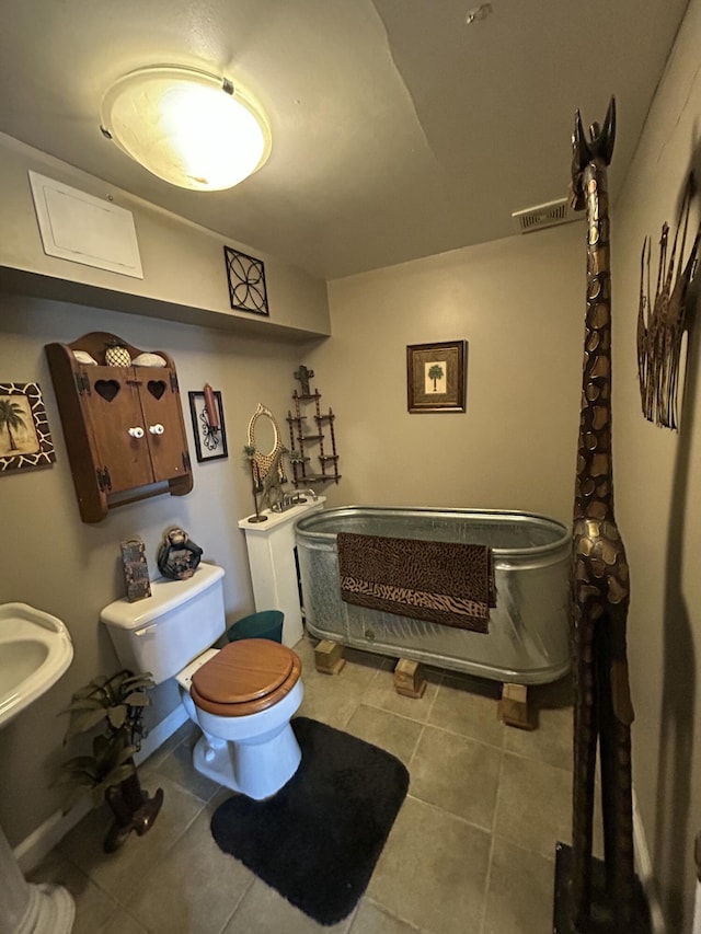 bathroom with tile patterned flooring and toilet