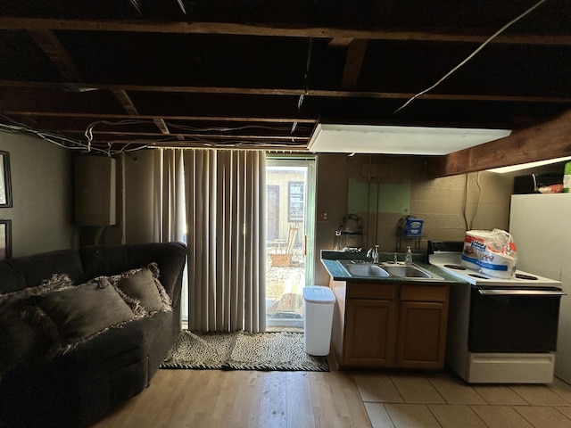 interior space featuring electric stove, a sink, a wealth of natural light, and light wood-style floors