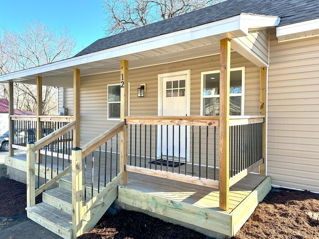 wooden terrace featuring covered porch