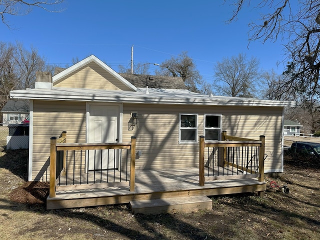 rear view of property with a wooden deck