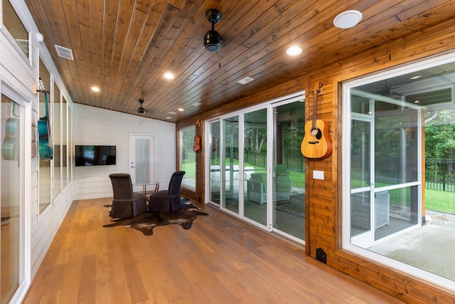 sunroom with wooden ceiling, visible vents, and vaulted ceiling