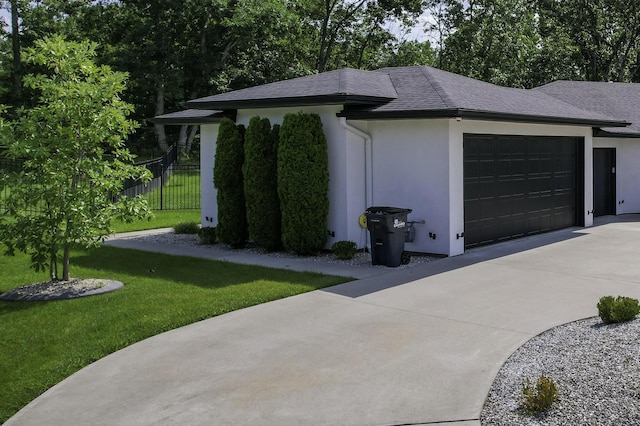 exterior space with concrete driveway and fence