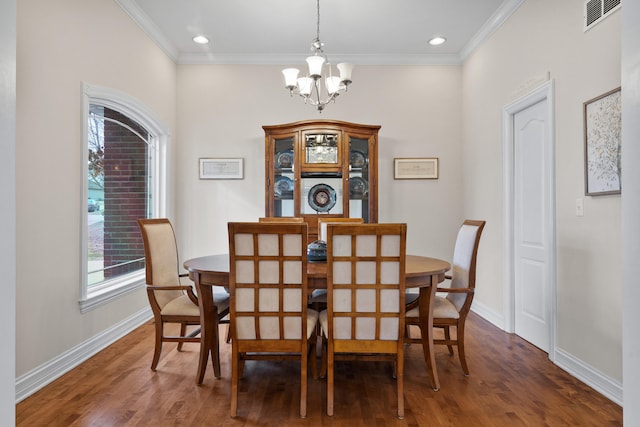 dining space with visible vents, crown molding, baseboards, and wood finished floors