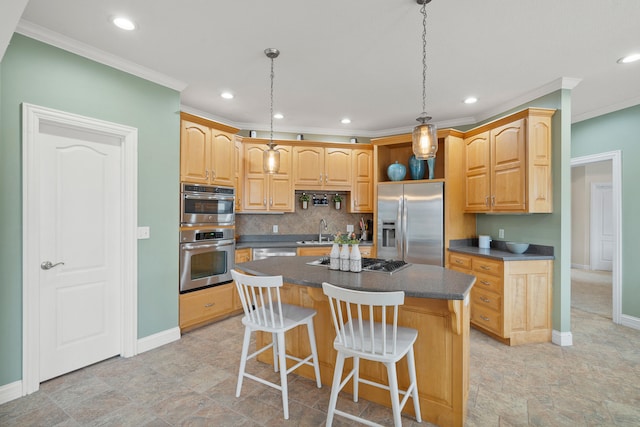 kitchen featuring a breakfast bar area, appliances with stainless steel finishes, backsplash, a center island, and dark countertops