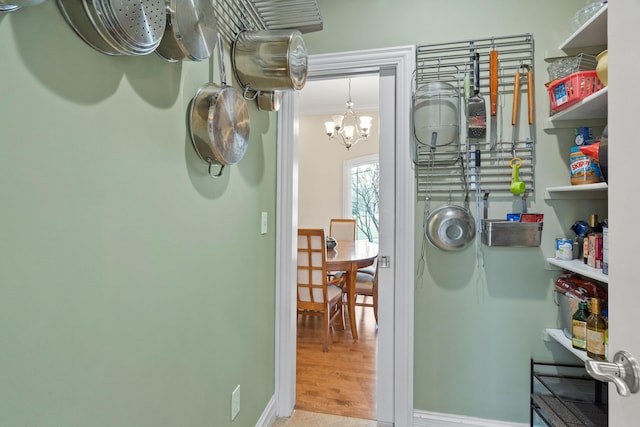 interior space featuring crown molding, baseboards, and wood finished floors