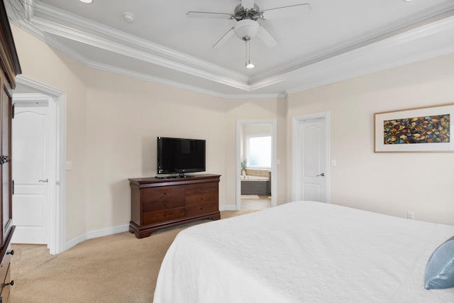 bedroom featuring crown molding, a raised ceiling, light carpet, connected bathroom, and baseboards