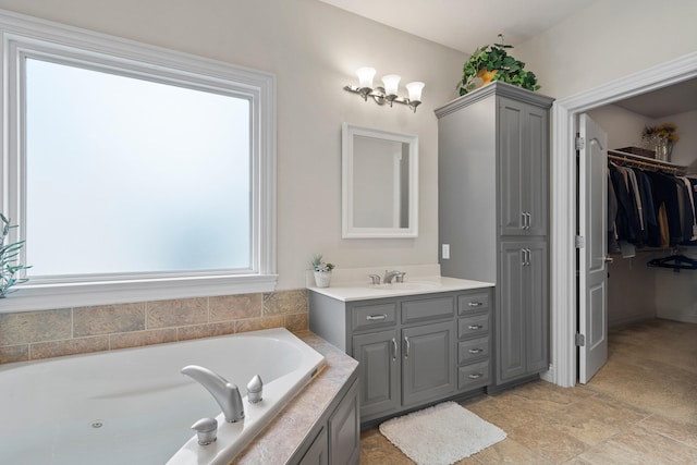 full bathroom with a spacious closet, a bath, and vanity