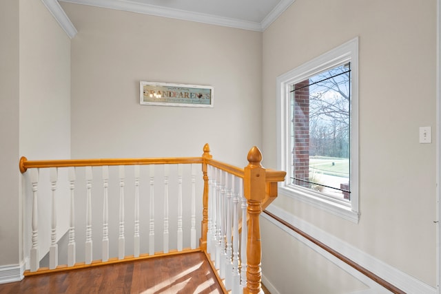 staircase featuring baseboards and crown molding