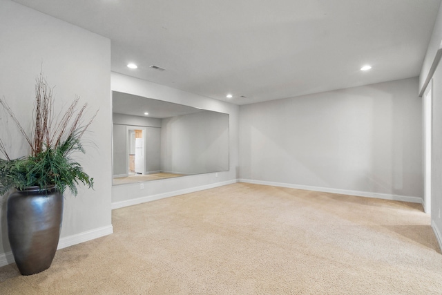 carpeted empty room featuring baseboards, visible vents, and recessed lighting