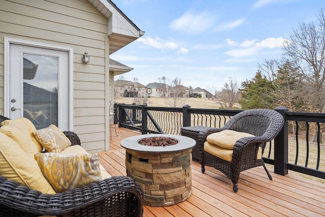 wooden terrace with an outdoor fire pit