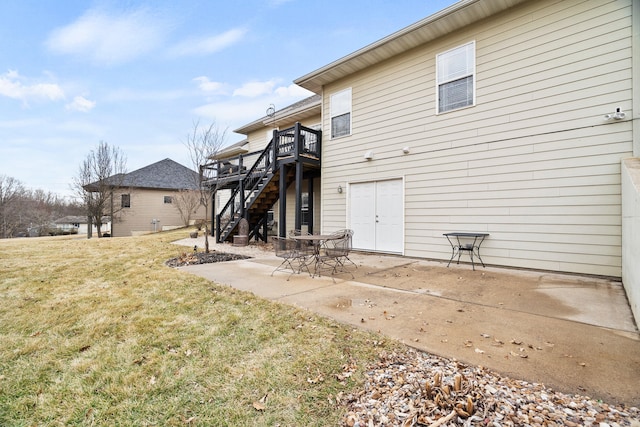 back of house with a patio area, stairway, a lawn, and a wooden deck