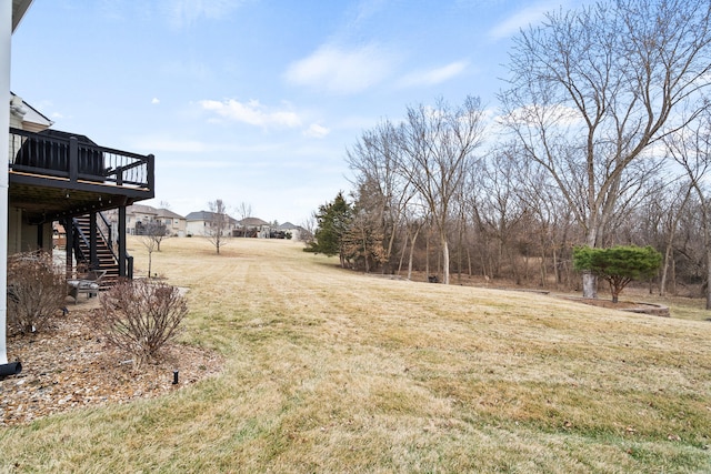 view of yard featuring a wooden deck and stairs