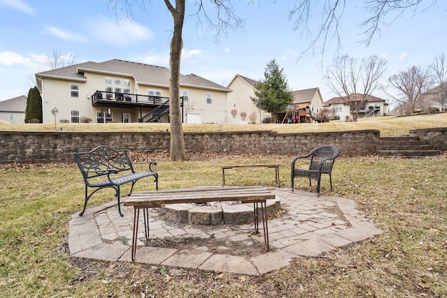 view of yard with an outdoor fire pit, a patio area, a deck, and stairs