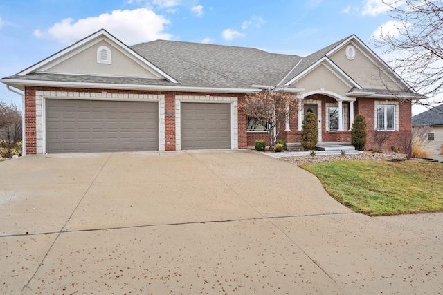 view of front of property with an attached garage, concrete driveway, and brick siding