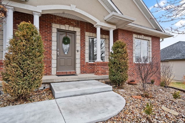 entrance to property with brick siding and stucco siding