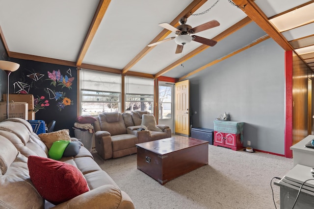 living area featuring ceiling fan, baseboards, lofted ceiling with beams, and carpet