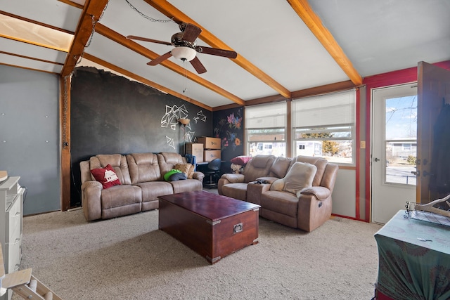 living area featuring vaulted ceiling with beams, ceiling fan, and carpet floors