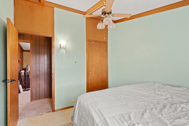 bedroom with a closet, ceiling fan, and baseboards