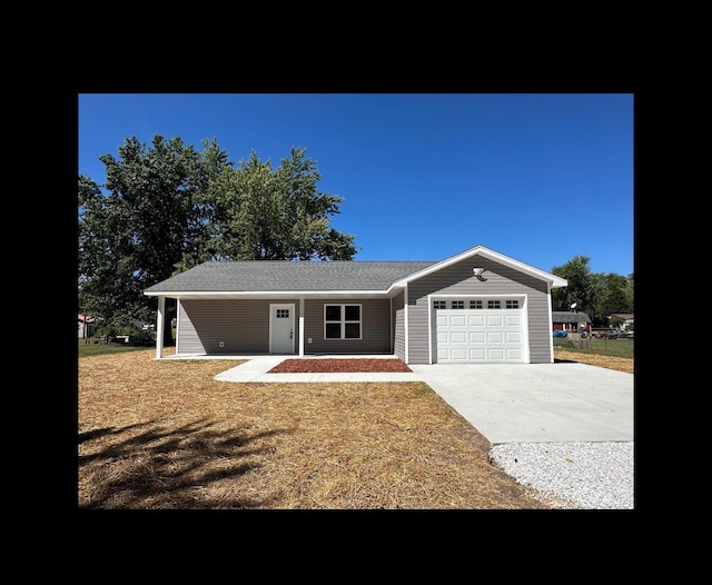 ranch-style home featuring a garage and concrete driveway