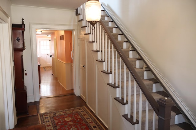 stairs featuring wood finished floors