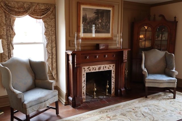 sitting room featuring wood finished floors and a tile fireplace