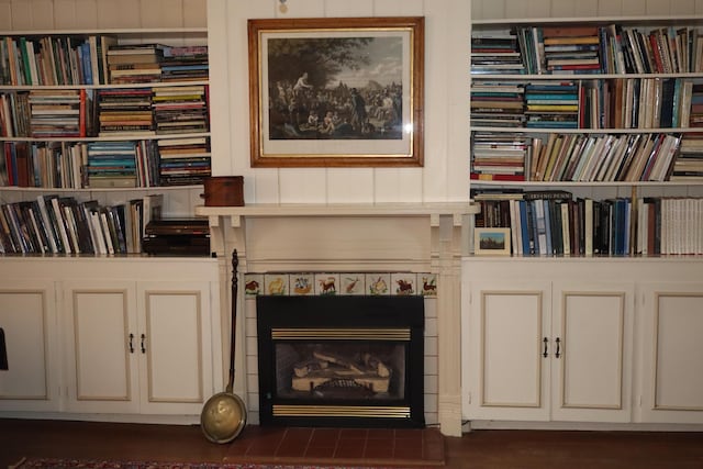 interior details featuring a tiled fireplace