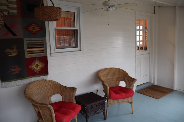 sitting room with a ceiling fan