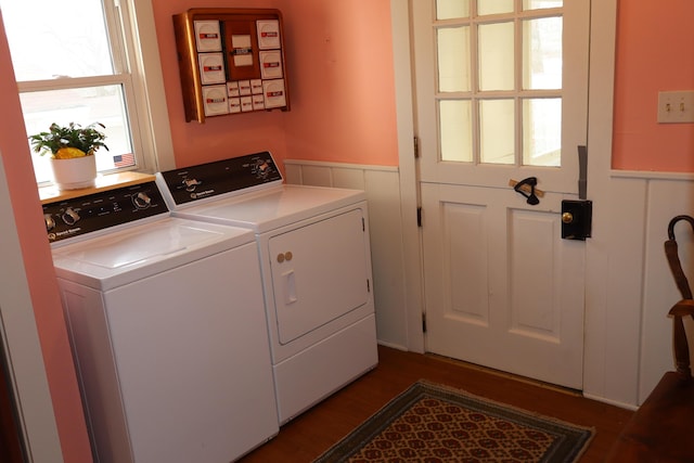 washroom featuring washer and dryer, dark wood finished floors, wainscoting, and laundry area