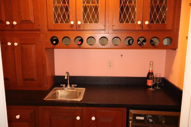 kitchen featuring a sink, wine cooler, and dark countertops