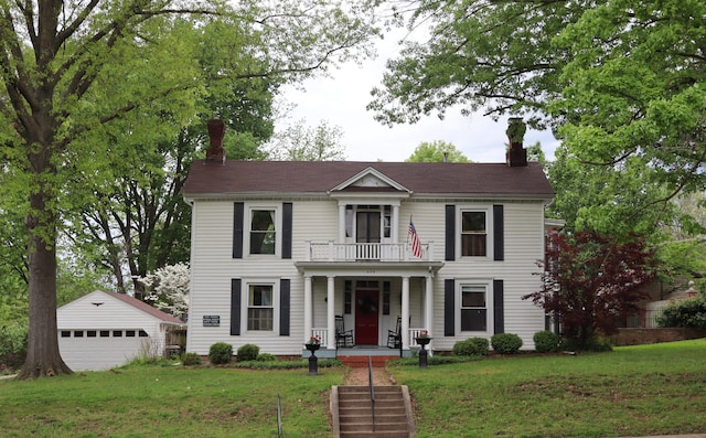 408 N Church St, Fayette, MO 65248 - view of front of property featuring a chimney, a balcony, covered porch, an outdoor structure, and a detached garage