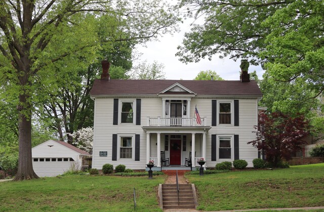 408 N Church St, Fayette, MO 65248 - view of front of property featuring a chimney, a porch, an outbuilding, and a garage