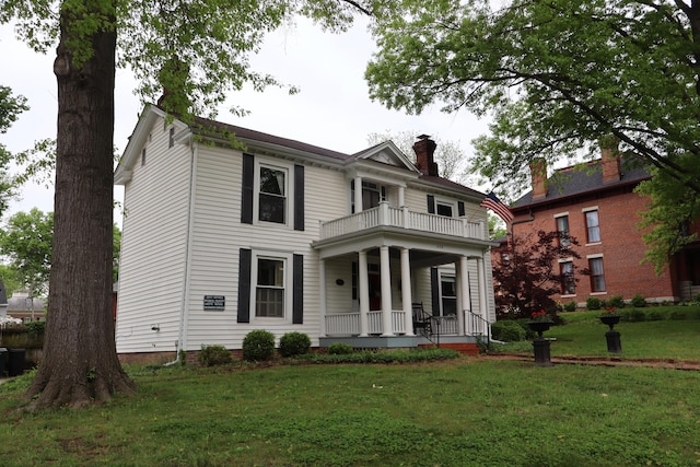 408 N Church St, Fayette, MO 65248 - view of front of home with a balcony, a porch, a front lawn, and a chimney