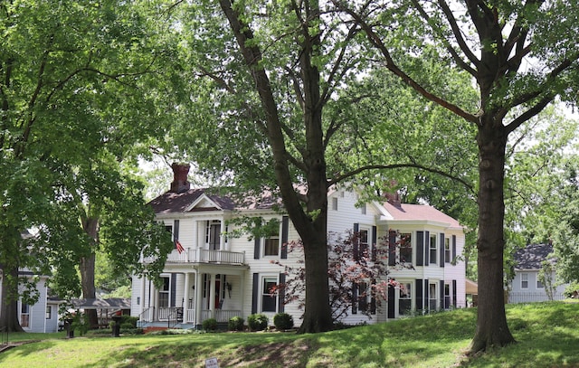 408 N Church St, Fayette, MO 65248 - view of front of house with a chimney, a porch, a front lawn, and a balcony