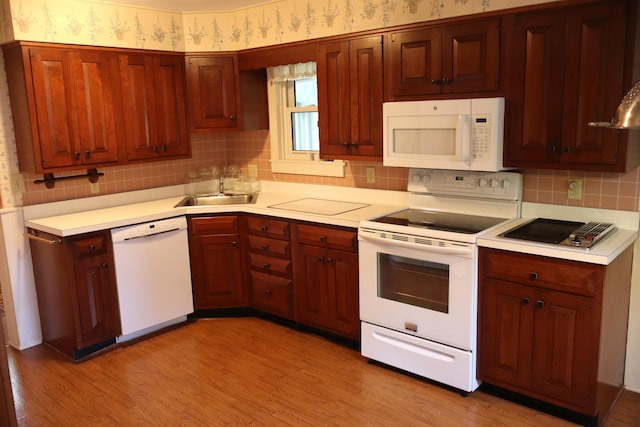 408 N Church St, Fayette, MO 65248 - kitchen with white appliances, wallpapered walls, light countertops, light wood-style floors, and backsplash