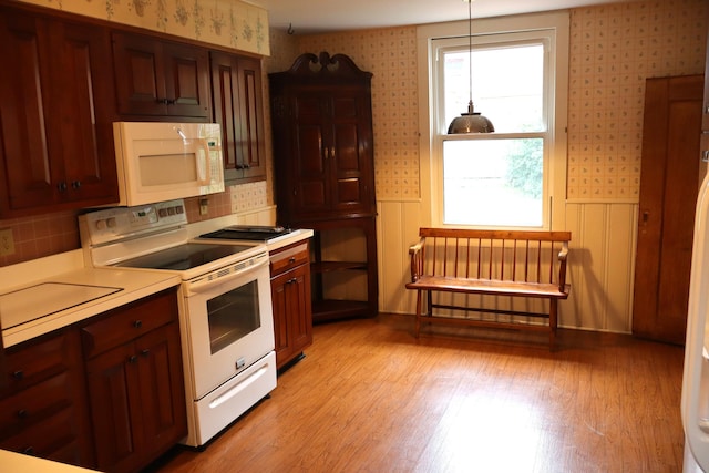408 N Church St, Fayette, MO 65248 - kitchen with white appliances, wallpapered walls, light countertops, tasteful backsplash, and light wood-style floors