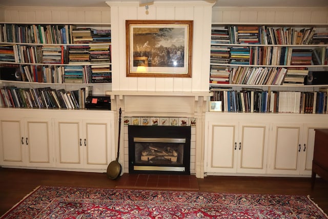 408 N Church St, Fayette, MO 65248 - living area featuring a tiled fireplace, crown molding, and dark wood-type flooring